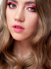 Fototapeta na wymiar Beautiful young blonde girl in monochrome makeup. Pink lips and eye shadow, delicate makeup.