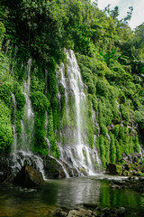 Fototapeta na wymiar Beautiful and scenic view of Asik-asik Falls in Alamada, Cotabato, Philippines. Water from this waterfalls comes directly from the wall of a towering mountain.