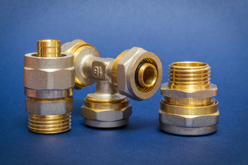 Three brass fittings is often used to connect for water and gas installations on blue background