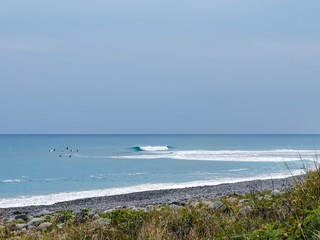 Surfers with some waves in front of Dulan and Donghe beach