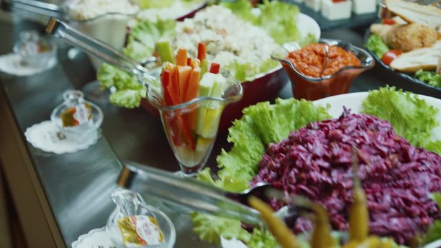 The camera flies over the buffet table