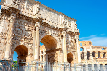 View of the Arch of Constantine in Rome at dawn, the walls of the Colosseum in the background....