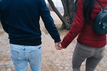 man and woman holding hands in park