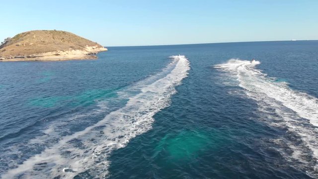 Two jetskis having fun