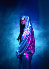 Neon portrait of a girl of Asian appearance, dressed in futuristic clothes and glasses. Neon blue and pink light. Virtual reality glasses and binary code in them.