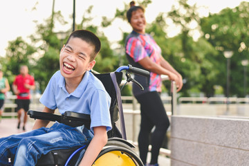 Disabled child on wheelchair is play and learn in the outdoor park like other people, Life in the education age of special children, Happy disability kid concept. - Powered by Adobe