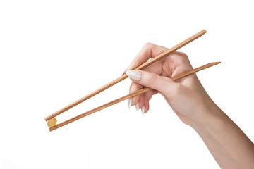 the female hand holds raisin wooden sticks is isolated on a white background