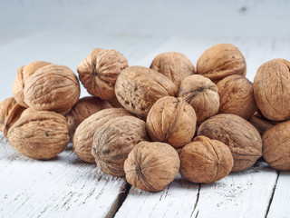 Walnuts lie on a light colored background
