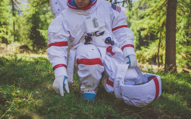 Astronaut exploring a new planet. Searching for a new home for humanity. Concept about science and...