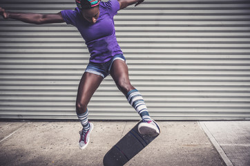 Young girl performing tricks with the skateboard