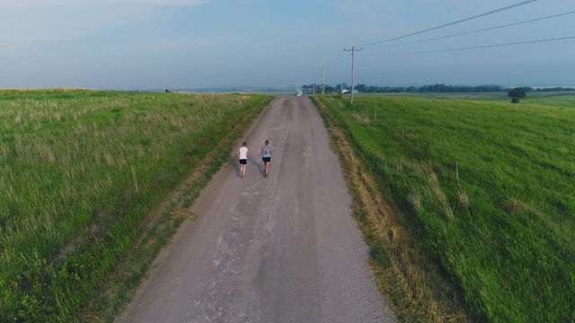 Runners on a dirt road