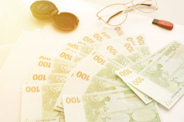 Euro banknotes, glasses and printing. Space for text