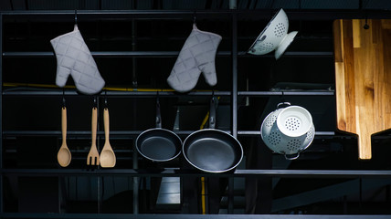 Cookware hanging on a metal rail for abstract background  