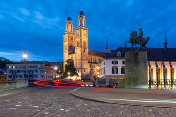 Fototapeta na wymiar Famous Grossmunster churche along river Limmat at night in Old Town of Zurich, the largest city in Switzerland