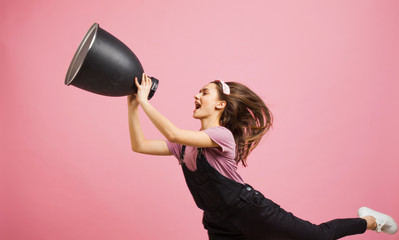 young activist shouts into a megaphone, a young girl in a jumpsuit