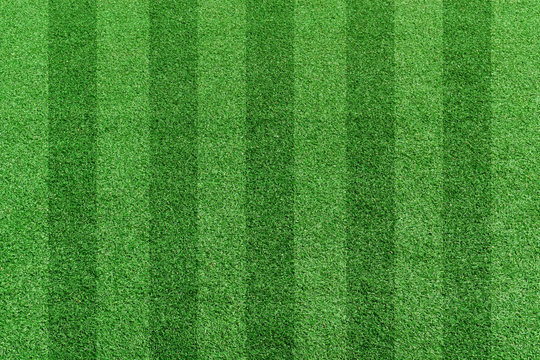 Top view stripe grass soccer field. Green lawn pattern background