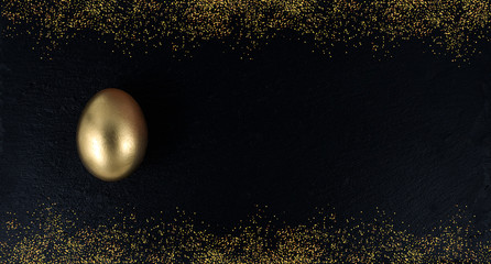 Minimal gold eggs easter concept. Golden egg with golden shine decorated confetti for banner, greeting card, social media advertise.Gold on black stone. Flat lay trendy easter greeting card copy space