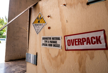 Radiation label beside the transport wooden box Type A package in the truck