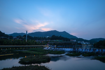 Fototapeta premium Artificial lakes, pavilions and running water in the setting sun