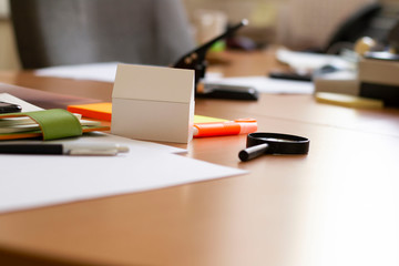 business life concept on the table lies smartphone paper notebook paper with white model of the house.