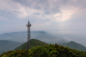 The hazy scenery of the mountain peak filled with clouds