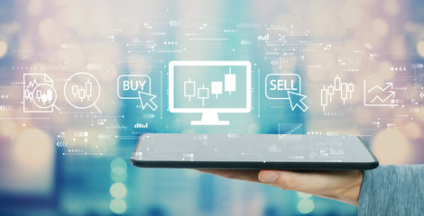 Stock trading theme with man holding a tablet computer