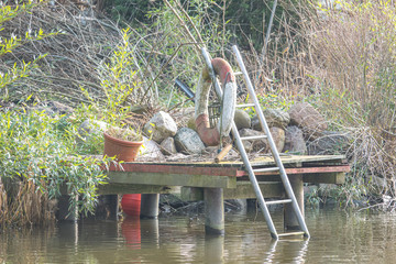 a small landing stage with a life ring is located at a lake