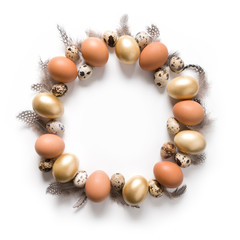 Easter wreath of golden, quail, chicken eggs isolated on white. View from above. Space for text.