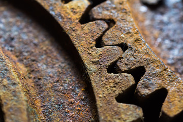 Rusty gears from old mechanism photographed at close range.