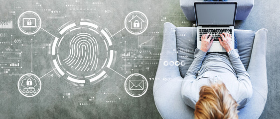 Fingerprint scanning theme with man using a laptop in a modern gray chair