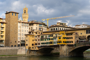 Fototapeta na wymiar Ponte Vecchio in Florence by day, with the lights reflecting in the water