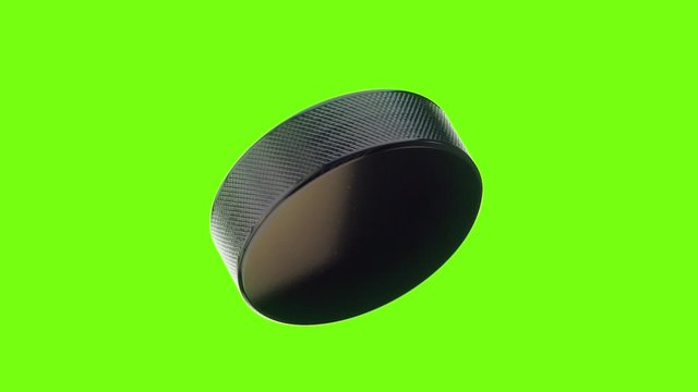 Hockey Puck with Reflections Rotates on Green Screen and Stops in Slow Motion