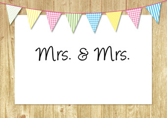 mrs. & mrs. poster at wooden fence with colorful bunting