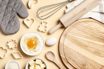 Baking utensils and ingredients. Colorful silicone cooking utensils, rolling pin, sugar sprinkling, whisk with cookie mold on a colored background. Baking concept. Place for text. Easter concept.