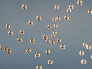 air bubbles on a water glass with blue gray background