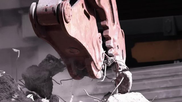 demolition excavator separating irons and concrete  on construction site , video hd footage