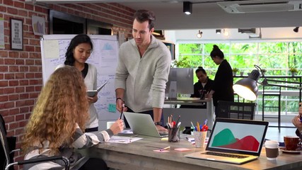 Group of businesspersons in creative business discussing work in the office .