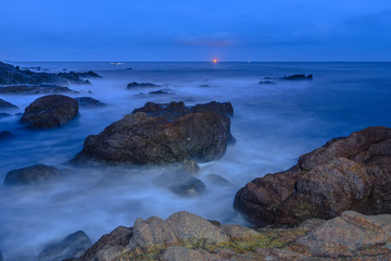 The Sea  of heads of hills, rocks singular, spray flying