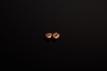 2 coffee seeds with black background