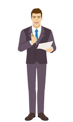 Smiling Businessman holding a pen and paper, pushing a button of a ballpoint pen and wants to write on paper. Full length portrait of Businessman in a flat style.