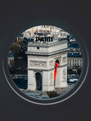 Arc de Triomphe seen through a circular window labeled Paris