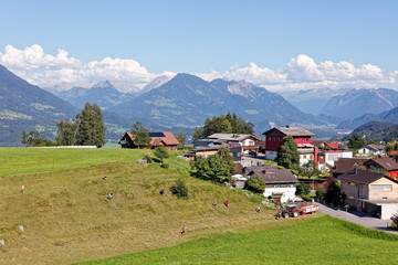 Fototapeta na wymiar Farmers in Alpine village Amerluegen
