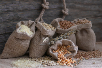 Grains of peas, rice, wheat, oats, buckwheat in bags.