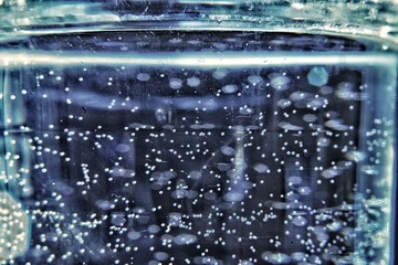 Water drops on glass, bubbles, blue and cool colours
