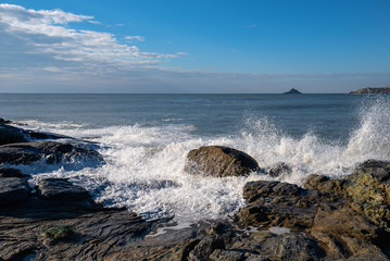 The island in the sea, the tide against the reef, the reef appears golden at dusk