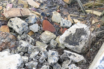 Construction waste with elements of and destroyed old structures at municipal landfill