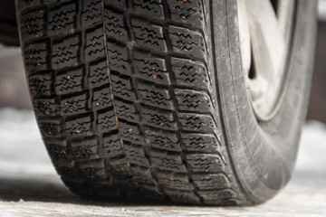 car tire with winter tires on snow with icicles
