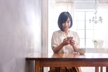 Beautiful Asian girl with laptop in cafe, education or technology or startup business concept, modern office or living room with copy space