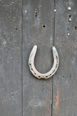 Old wooden horseshoe on wooden wall