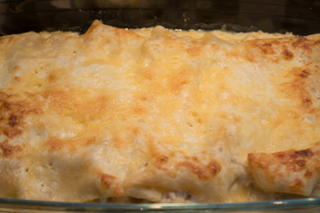 glass culinary container with baked fresh hot lasagna